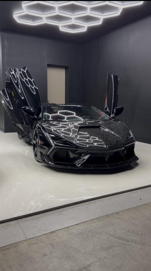 Mansory Lamborghini Revuelto with doors raised under hex lighting